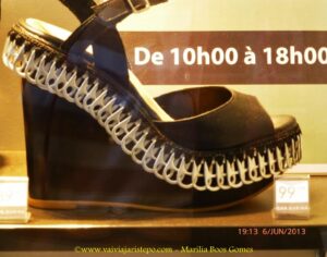 Uma sandália alta, enfeitada com lacres de latas.